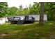 Home's backyard with wooden deck and stairs leading to a lush lawn at 6538 N Tutterow Rd, Monrovia, IN 46157