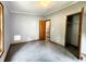 Bedroom with neutral carpet, gray walls, window, door to closet, and door to another room at 6538 N Tutterow Rd, Monrovia, IN 46157