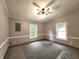 Bedroom featuring neutral carpet, gray walls, white trim, ceiling fan, and two windows providing natural light at 6538 N Tutterow Rd, Monrovia, IN 46157