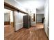 Bright dining area featuring wood laminate floors, decorative lighting, and view of other rooms at 6538 N Tutterow Rd, Monrovia, IN 46157