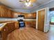 Well-equipped kitchen with wood cabinets, modern appliances, and laminate flooring at 6538 N Tutterow Rd, Monrovia, IN 46157