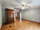 Inviting living room featuring decorative wood armoire, wood look flooring, gray walls, and double doors at 6538 N Tutterow Rd, Monrovia, IN 46157