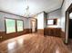 Open living room with wood-look flooring, paneled walls, natural light from windows, and built-in cabinetry at 6538 N Tutterow Rd, Monrovia, IN 46157