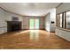 Inviting living room featuring a brick fireplace, wood floors, and French doors leading to the exterior at 6538 N Tutterow Rd, Monrovia, IN 46157