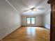 Spacious living room with light-colored walls, wood-look flooring, and bright natural light from the window at 6538 N Tutterow Rd, Monrovia, IN 46157