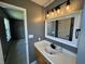 Clean and bright bathroom featuring a vanity with modern lighting at 660 White Ash Trail, Mooresville, IN 46158