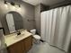 Well-lit bathroom with white marble floors, neutral walls, and a shower with white curtain at 660 White Ash Trail, Mooresville, IN 46158