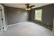 Cozy bedroom with neutral carpet, a ceiling fan, and a bright window at 660 White Ash Trail, Mooresville, IN 46158