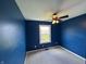 Bright bedroom with blue accent walls, neutral carpet, and a ceiling fan at 660 White Ash Trail, Mooresville, IN 46158