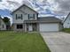 Charming two-story home featuring a brick facade, attached two-car garage, and well-maintained lawn at 660 White Ash Trail, Mooresville, IN 46158