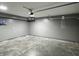 An attached two car garage with gray walls and a light colored cement floor with an electrical panel at 660 White Ash Trail, Mooresville, IN 46158