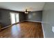 Spacious living room with hardwood floors, ceiling fan, and access to the backyard through glass patio doors at 660 White Ash Trail, Mooresville, IN 46158