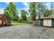 Large backyard features a patio, basketball hoop, playset, storage shed, and mature trees at 6605 Grosvenor Pl, Indianapolis, IN 46220