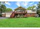 Charming home with a spacious backyard, including a deck, patio area, and well-maintained lawn for outdoor enjoyment at 6605 Grosvenor Pl, Indianapolis, IN 46220