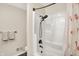 This bathroom features a shower with flamingo curtain, a toilet, and a towel rack with towels at 6605 Grosvenor Pl, Indianapolis, IN 46220