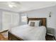 Bedroom with hardwood floors, light blue walls, and a large window at 6605 Grosvenor Pl, Indianapolis, IN 46220