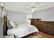 Bedroom with hardwood floors, ceiling fan, dresser, and ample natural light at 6605 Grosvenor Pl, Indianapolis, IN 46220