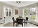 Charming dining area with a table, chairs, and multiple windows providing ample natural light at 6605 Grosvenor Pl, Indianapolis, IN 46220
