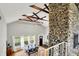 Airy dining room with vaulted ceilings, stone fireplace and natural light at 6605 Grosvenor Pl, Indianapolis, IN 46220