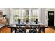 Bright dining area with lovely table setting, large windows and natural light at 6605 Grosvenor Pl, Indianapolis, IN 46220