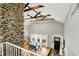 Bright dining room with vaulted ceilings, stone fireplace and abundant natural light at 6605 Grosvenor Pl, Indianapolis, IN 46220