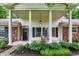 Inviting front porch with rocking chairs and lovely landscaping at 6605 Grosvenor Pl, Indianapolis, IN 46220