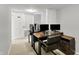 This home office with desks and great lighting provides a perfect space for focused work and productivity at 6605 Grosvenor Pl, Indianapolis, IN 46220