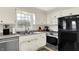 Functional kitchen with stainless steel appliances, white cabinetry, and a window view at 6605 Grosvenor Pl, Indianapolis, IN 46220