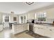 Bright, well-equipped kitchen featuring stainless steel appliances and white cabinets with lots of natural light at 6605 Grosvenor Pl, Indianapolis, IN 46220