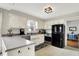 Classic kitchen with white cabinets, stainless steel appliances, and a view to a dining area, perfect for Gathering meals at 6605 Grosvenor Pl, Indianapolis, IN 46220