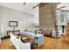 Open floor plan with stone fireplace, staircase, and dining table at 6605 Grosvenor Pl, Indianapolis, IN 46220