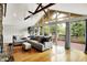 Bright living room showcasing large windows, hardwood floors, and access to a deck for outdoor enjoyment at 6605 Grosvenor Pl, Indianapolis, IN 46220