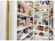 Well-stocked pantry with organized shelves full of various food items and storage containers at 6605 Grosvenor Pl, Indianapolis, IN 46220