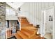 Beautiful hardwood staircase with white railing leads to the upper level of this home at 6605 Grosvenor Pl, Indianapolis, IN 46220