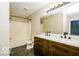 Modern bathroom featuring double sinks, a large mirror with lighting, and a shower-tub combo at 6756 Wimbledon Dr, Zionsville, IN 46077