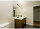 Bathroom featuring double sinks, quartz countertops, and a large mirror with lighting at 6756 Wimbledon Dr, Zionsville, IN 46077