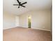 Bright bedroom features neutral paint, carpet, a ceiling fan, and two closets with doors at 6756 Wimbledon Dr, Zionsville, IN 46077