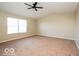 Spacious bedroom with neutral paint, carpet, large window, and overhead ceiling fan at 6756 Wimbledon Dr, Zionsville, IN 46077
