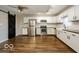 Modern kitchen with white cabinets, stainless steel appliances, and a farmhouse sink with black hardware at 6756 Wimbledon Dr, Zionsville, IN 46077