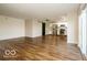 Open concept living area with hardwood floors, slider to deck, and views into the kitchen with stainless appliances at 6756 Wimbledon Dr, Zionsville, IN 46077