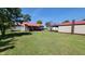 Large backyard with mature trees featuring a home, garage, and car parked on the driveway at 705 S 450 E, Franklin, IN 46131
