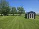Spacious backyard featuring a storage shed, mature trees, and a well-maintained lawn at 705 S 450 E, Franklin, IN 46131