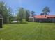 Charming backyard featuring lush green grass, mature trees, and a cozy single-Gathering home at 705 S 450 E, Franklin, IN 46131