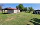 Spacious backyard featuring a large garage, covered area, and small storage shed at 705 S 450 E, Franklin, IN 46131