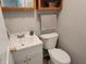 Neat half-bathroom featuring updated sink, lighting, and vanity storage at 705 S 450 E, Franklin, IN 46131