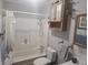 Clean bathroom featuring a shower-tub combo, toilet, and vanity with framed mirror at 705 S 450 E, Franklin, IN 46131