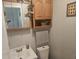 Cozy half-bathroom featuring updated sink, lighting, and storage cabinet at 705 S 450 E, Franklin, IN 46131