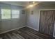 Bedroom with laminate flooring, sliding barn door closet, and large window at 705 S 450 E, Franklin, IN 46131