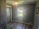 This bedroom has modern laminate flooring, new ceiling fan, and large window at 705 S 450 E, Franklin, IN 46131