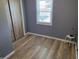 Bedroom featuring a built-in closet, vinyl floors, light walls, and a bright window at 705 S 450 E, Franklin, IN 46131
